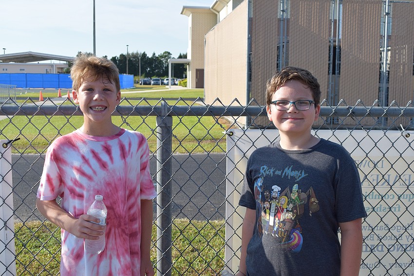 Fifth-graders Cannon Thacker and Landon Dickens take a break from the walk-a-thon to get some water.