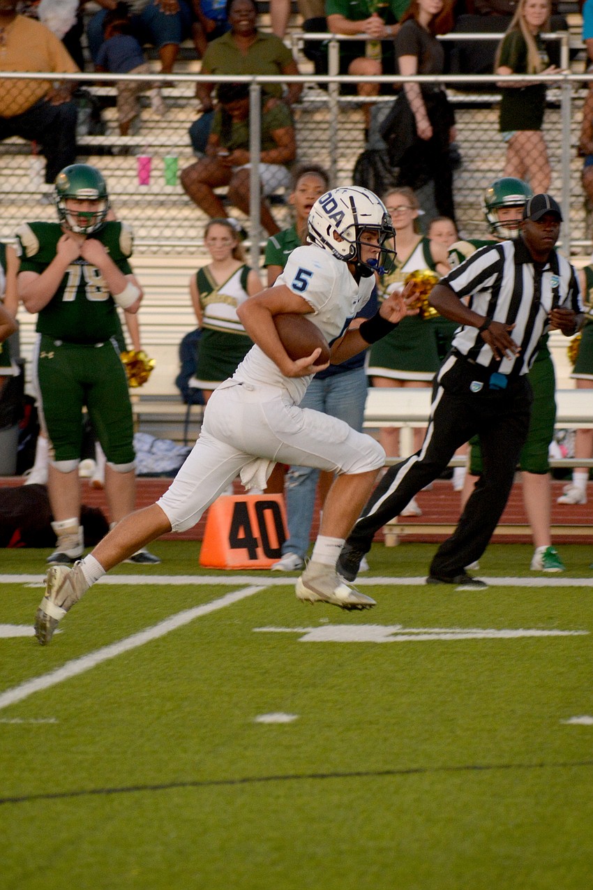 ODA quarterback Tyler Beasley scrambles upfield.