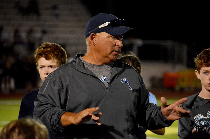 ODA coach Chris Kempton speaks to his team following the 48-7 loss.