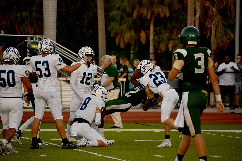 ODA's Patrick O'Keefe (8) and Grady Paxton (23) toss a Saint Stephen's running back to the turf.