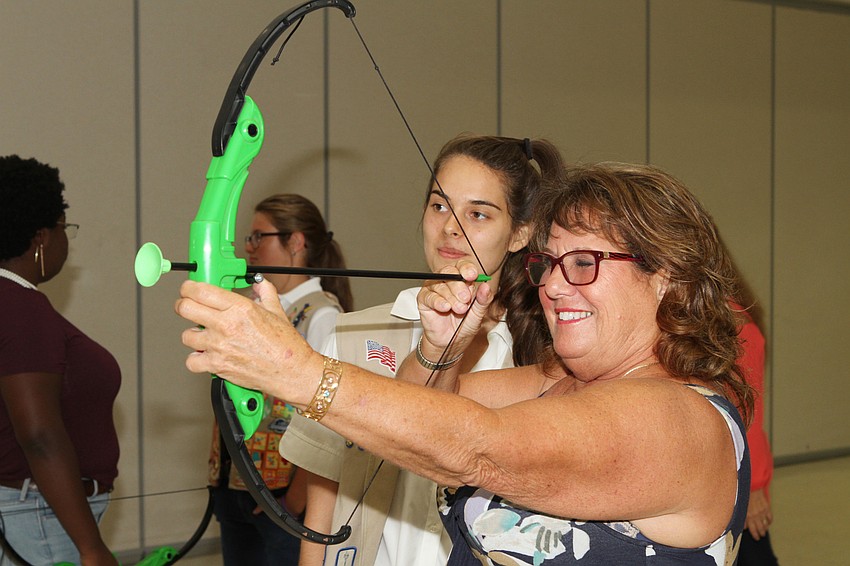 Jeanni Castro helped Catherine Carmack line up her shot.
