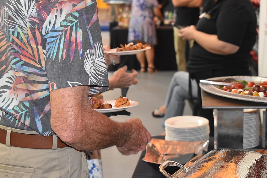 Jim Larson grabs a few appetizers.