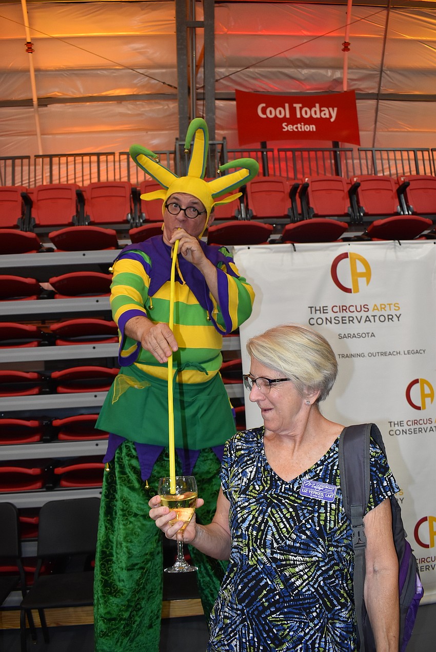 Aaron Watkins tries to sip Liz Yerkes' champagne from above.