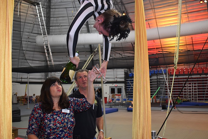 Rikki Hettig-Rolfe Meaux pours champagne for Beth Graves from above.
