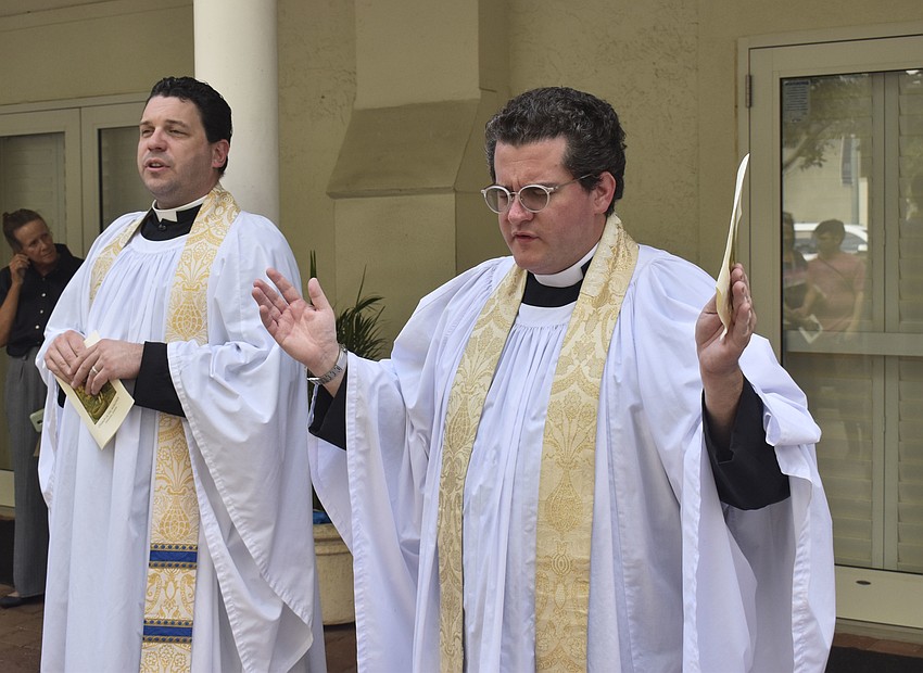 Father Christian Wood and Father Charleston Wilson lead the congregation in the Lord's Prayer.
