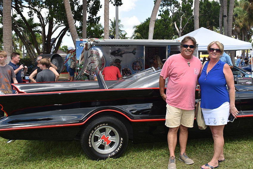 Rob and Lorraine Kenny in front of a Batman-themed car.