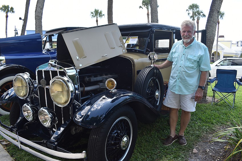 Bob Zuhone stands proudly next to his car.