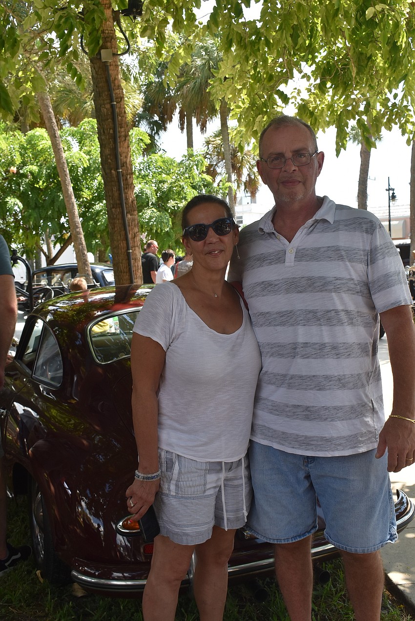 Lillian and John Langke in front of one of the older cars.