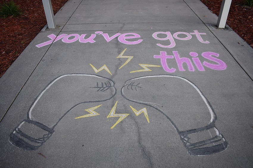 The PTO created chalk drawings to share messages of support for fourth grade teacher Sarah Body. The drawings are on the sidewalk leading up to the entrance of the school.