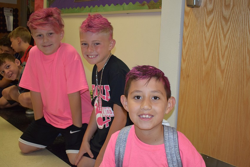 Lex Duis, Anthony Spino and Aryan Aguilera dyed their hair pink and dressed in pink. Spino also had breast cancer awareness ribbons painted on the sides of his head.