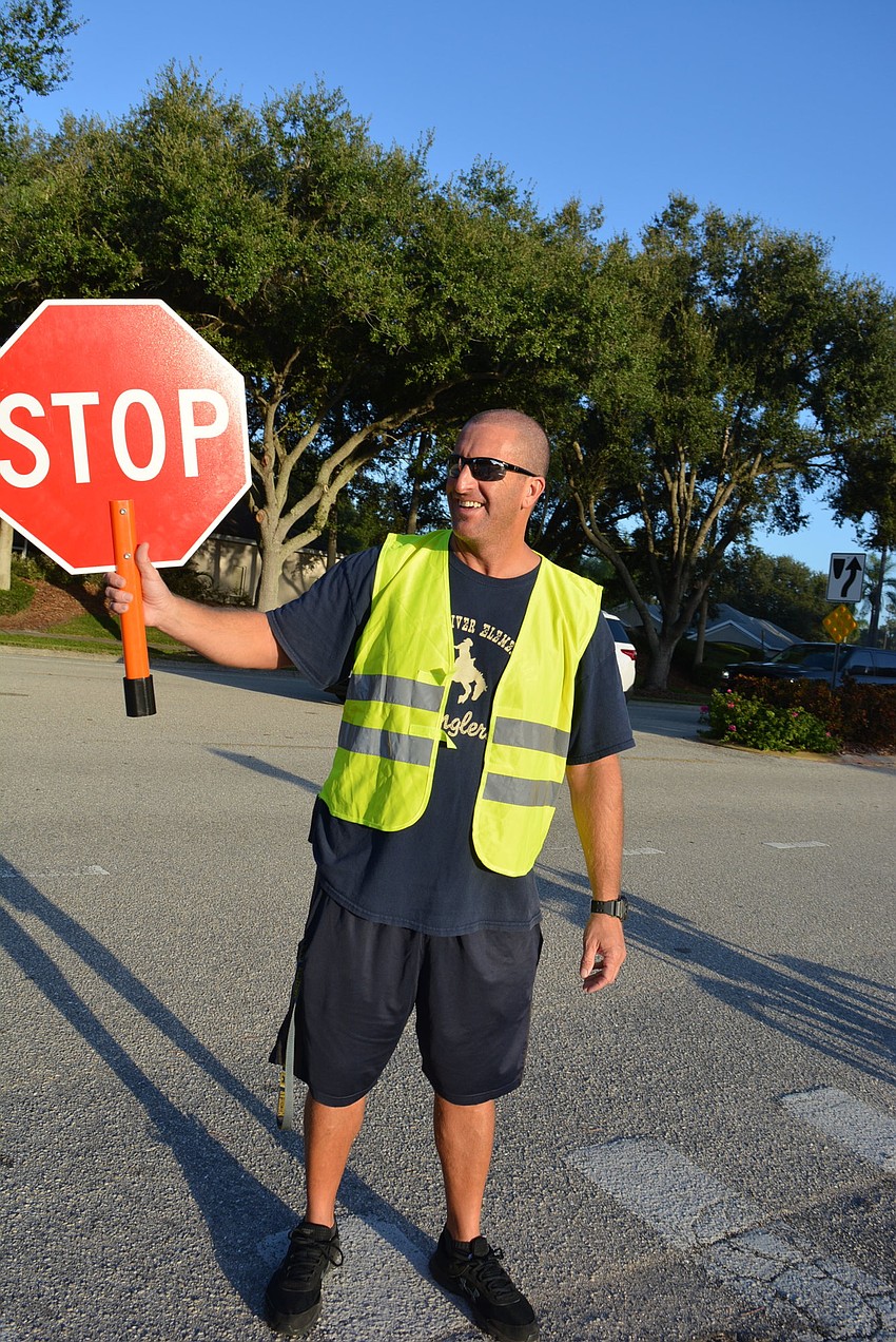 Instructor Eric Boso, called coach B, helps make sure students cross the street in front of the school safely.
