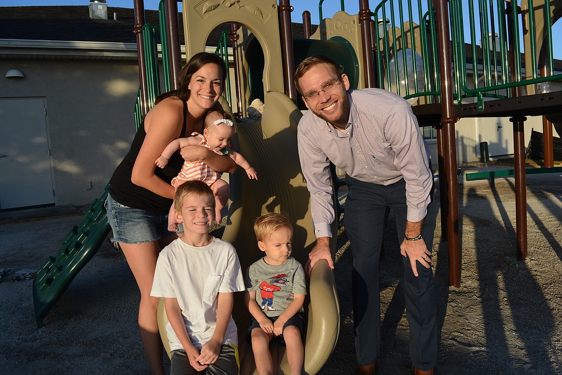 The Free family is excited about the installation of a playground at Risen Savior Lutheran. It marks the start of a preschool program. Pictured are Kristin and Pastor Caleb Free with their children, JoJo, Clay and Aaron.