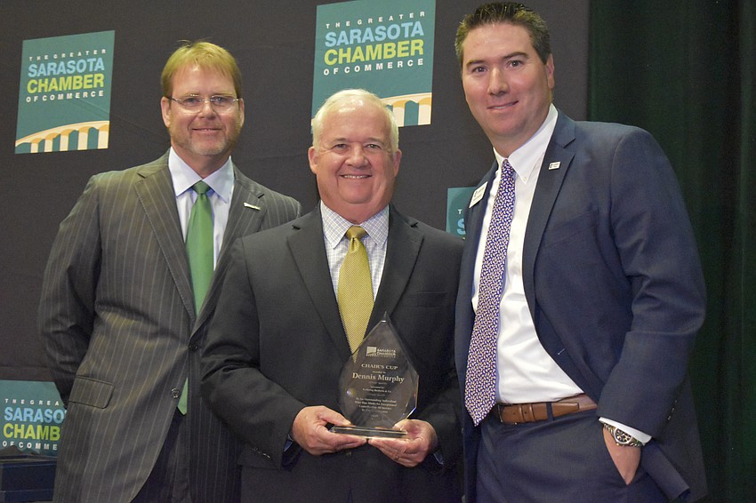 John LaCivita and Rob Lane present Dennis Murphy with the Chair's Cup Award.