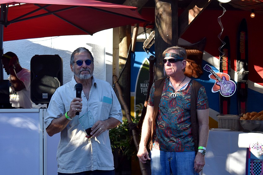 Michael Shay accepts an award as Mark Smith presents it.