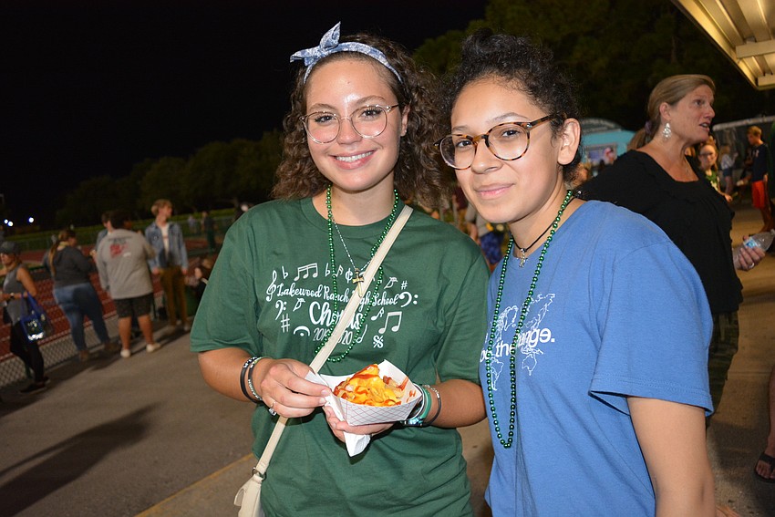 Senior Izzie Uribe and junior Helen Krull enjoy a snack at the homecoming game.