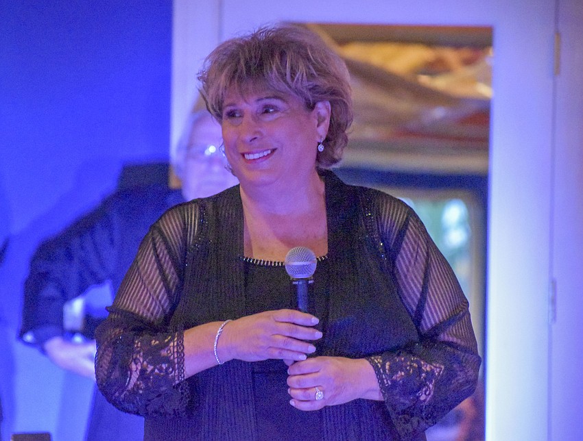 Founder Marsha Panuce watches as the crowd sings her Happy Birthday.