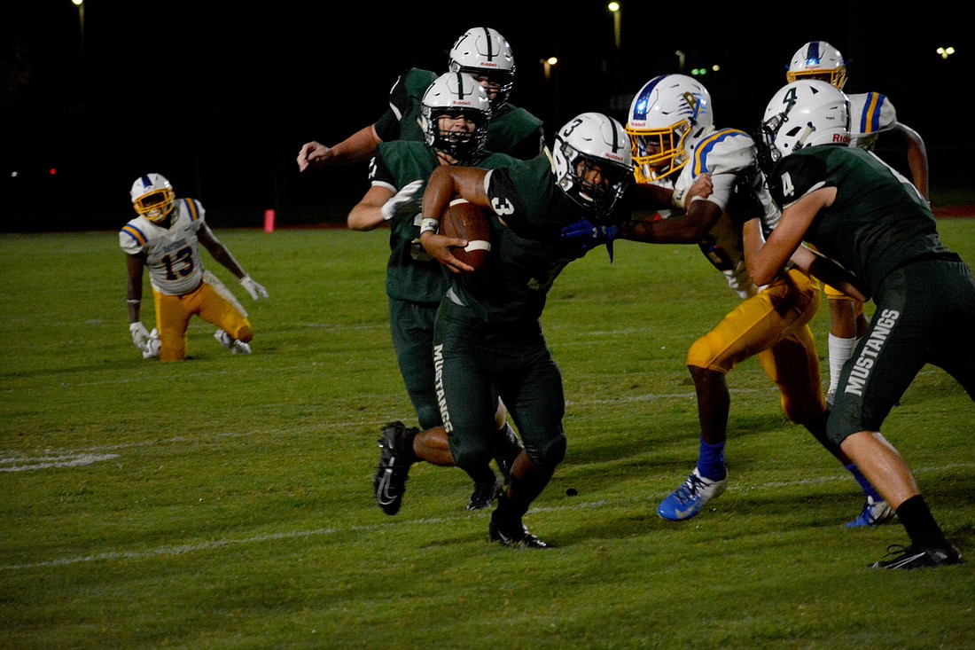 Lakewood Ranch senior running back Isaiah Harrison stiff arms a Bayshore High defender.