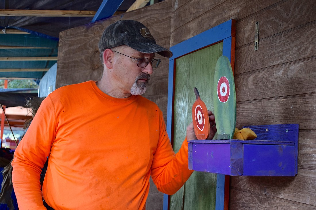 Jim Baar sets up the knock-down targets of the game Hillbilly Quick Draw.