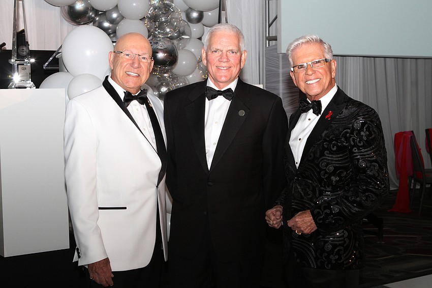 Emcee Bob Nosal , President and CEO Richard Carlisle, and emcee Bob Trisolini