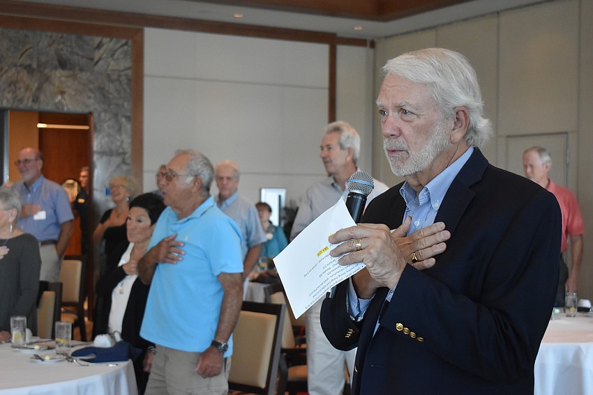 Ken Marsh leads the club in the Pledge of Allegiance.