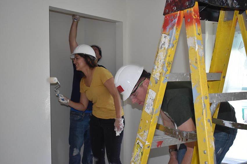 Michael Bodnyk and Jaclyn and Brent Campbell work together in one room.