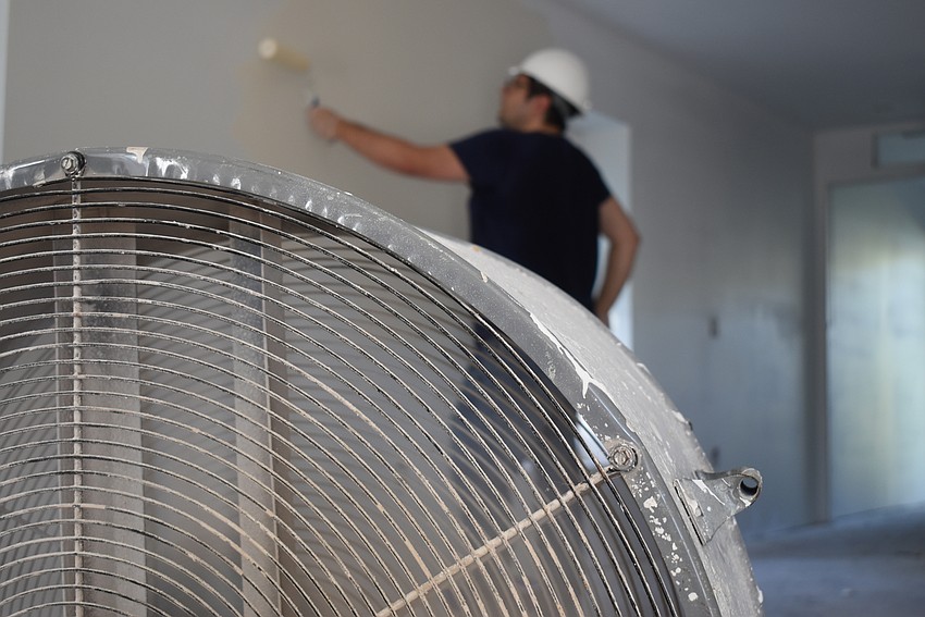 Michael Bodnyk paints in a coveted spot near the fan.