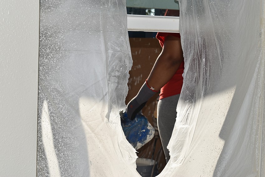 Robin Chacon through the currently open window of her future home.