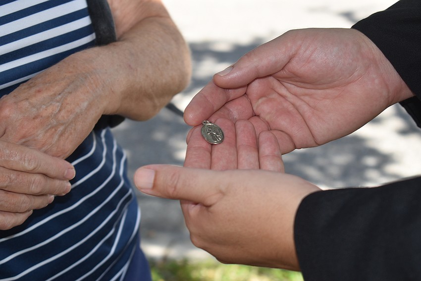 Father Dave Marshall blesses Reba's St. Francis charm.