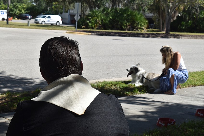 Father Dave Marshall gives Poppy her space as Kriston Barnett sits with her.