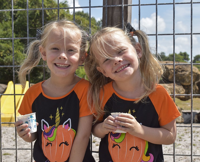 Twins Dallas and Payton Guagnini, 5, enjoy their time at the festival after traveling from Pinellas County.
