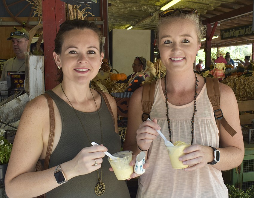 Courtney Rubendunst and Lindsey Hankinson eat pumpkin ice cream.