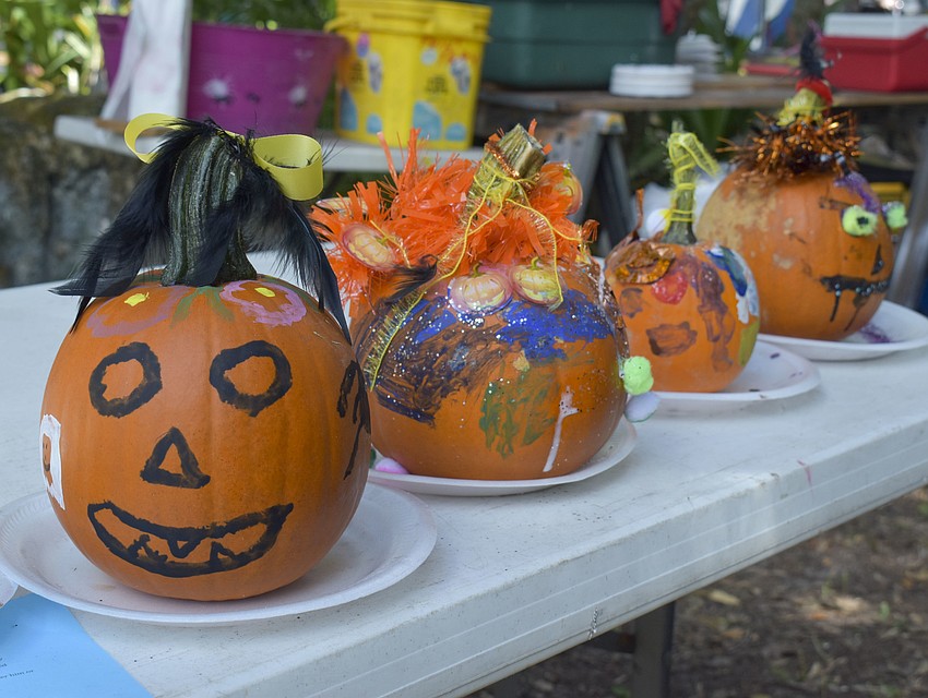 Festival goers are able to paint pumpkins.