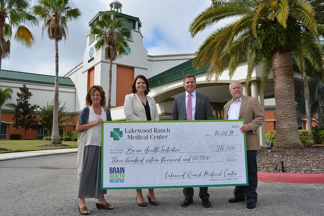 Brain Health Initiative Executive Director Stephanie Peabody, LWR Communities&#39; Monaca Onstad, Lakewood Ranch Medical Center CEO Andy Guz and Schroeder-Manatee Ranch President and CEO Rex Jensen celebrate the hospital&#39;s donation.
