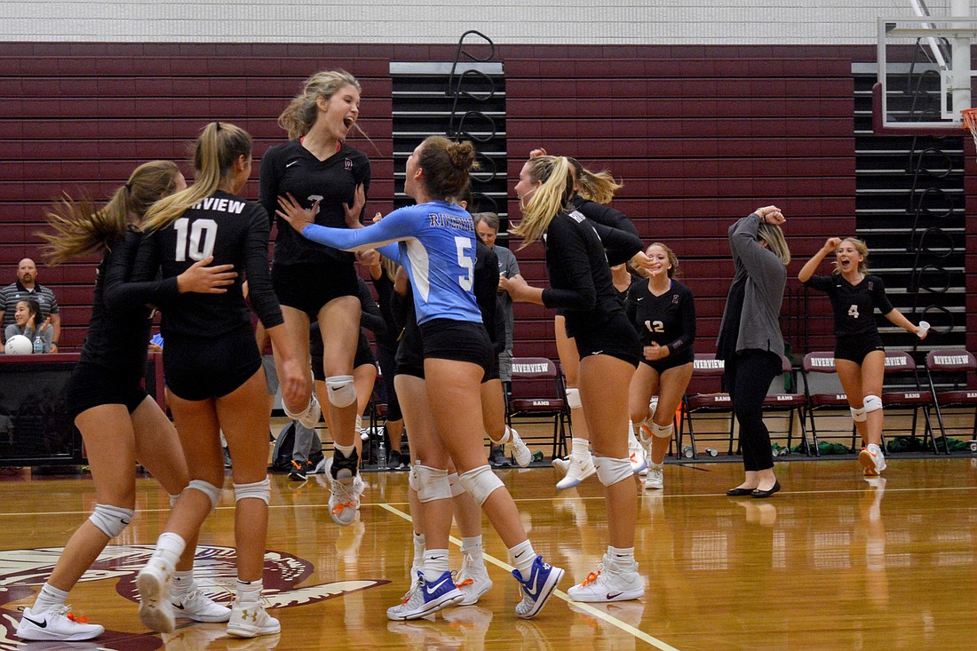 Maddie Walker (3) jumps into Riah Walker&#39;s (5) arms after Riverview beat Venice High.