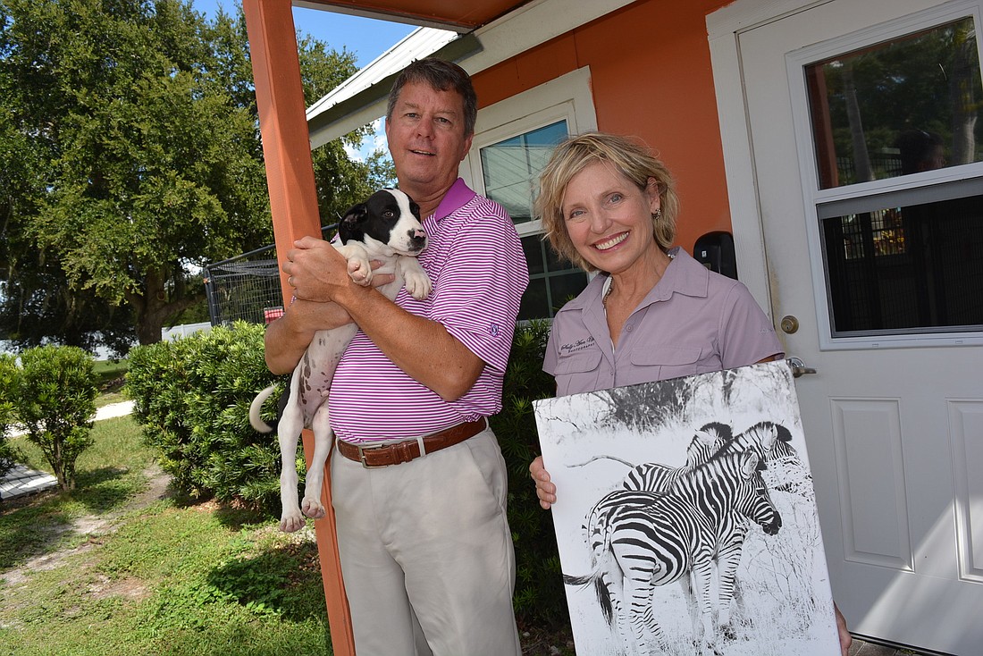 Nate&#39;s Honor Animal Rescue Director of Development Rob Oglesby with University Park resident and photographer Sally Ullman hope an upcoming photography show will raise funds for Nate&#39;s.