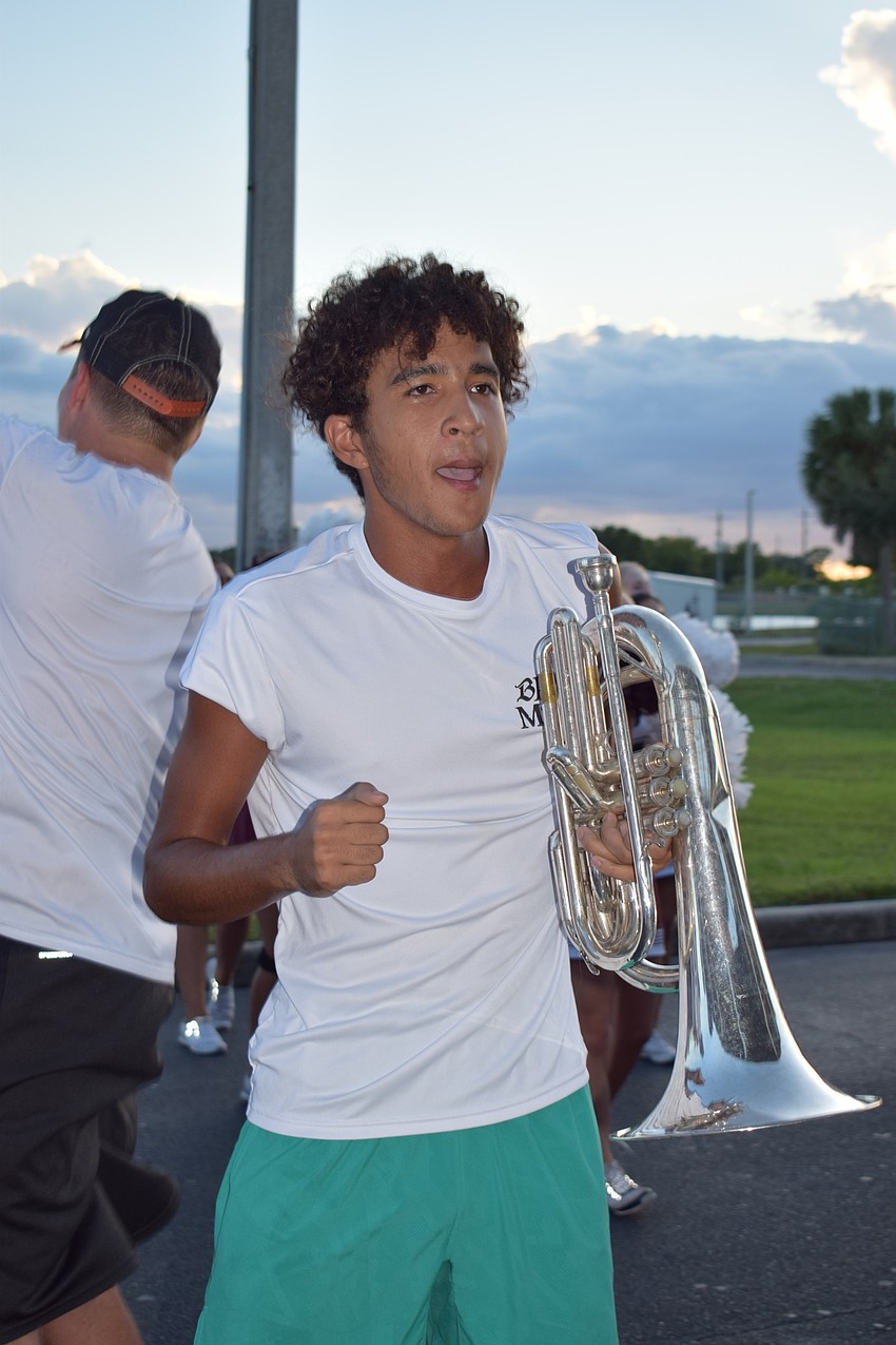 Senior Braden Hameed performs with the Marching Band of Pirates in his final homecoming bonfire.