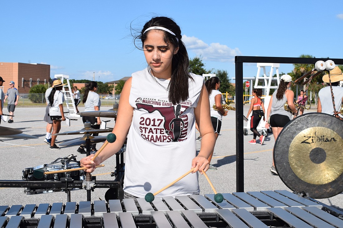 Aqila Patel, a Braden River High School senior, plays xylophone as part of the pit in the band.