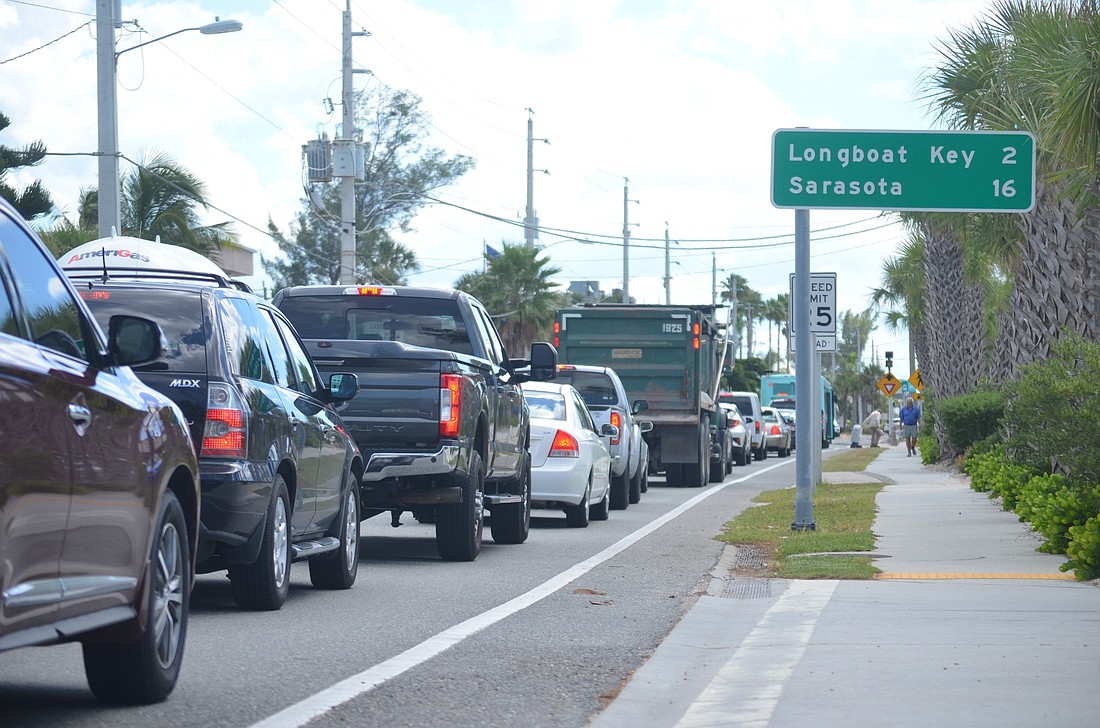 Traffic begins backing up as a Manatee County transit bus stops a few hundred yards south of the intersection of Gulf Drive and Cortez Road.