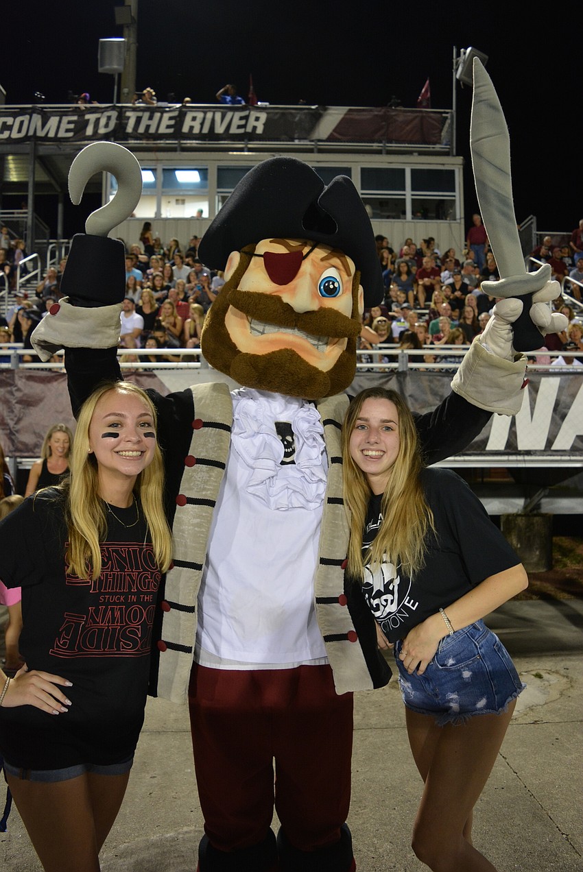Senior Sebastian Colosia (center), with friends Mary Kate Nolan (left) and Lexi Farmer (right) get the crowd excited with the school mascot, Capt. Crossbones.