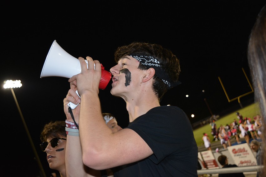 Senior Liam Antoszewski, a section leader and Student Government Association senator, leads the crowd in chanting 
