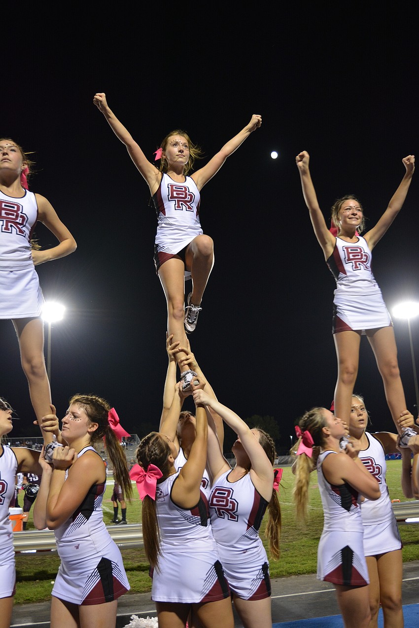 Varsity cheerleaders Lucie Dunlap, Savannah Grill and Hallie Bouchard lead the crowd in shouting 