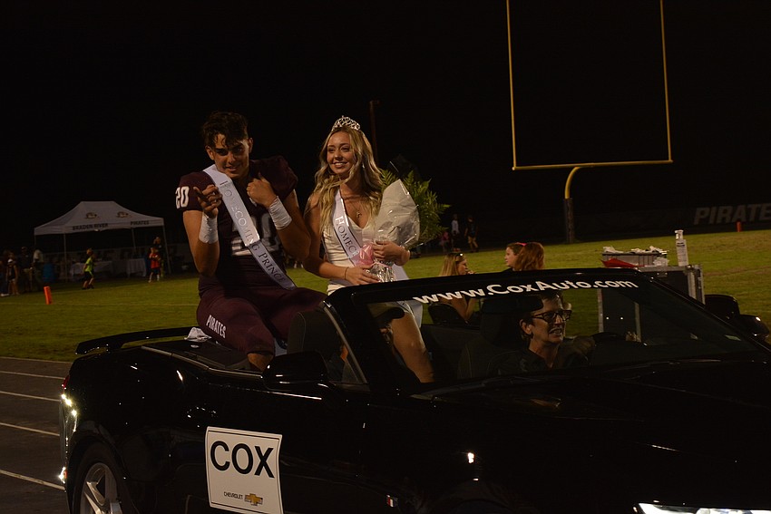 Homecoming senior prince and princess D'Angelo Antonino and Zoe Gillson wave to the crowd.