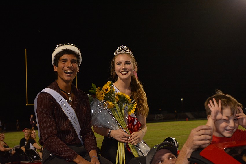 Homecoming king and queen Juan Brito and Morgan Christiansen enjoy a victory ride.