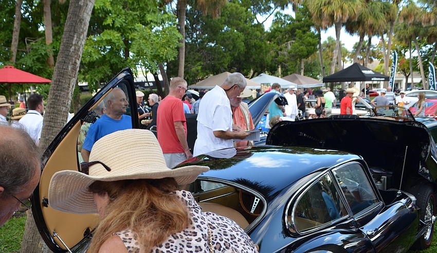 Bill Nieland, left in blue, watches as judges pore over his black E-type.