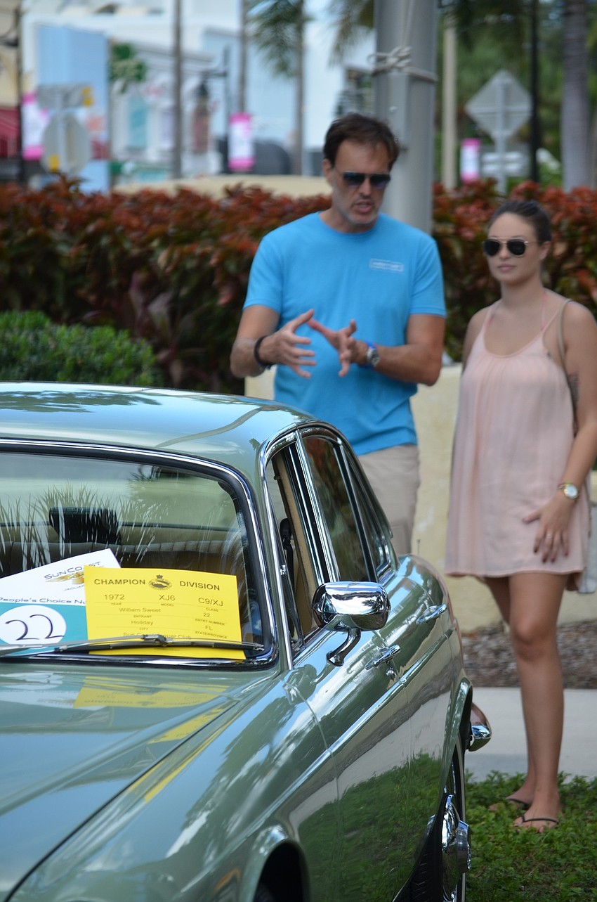 Doug King of Sarasota and his daughter, Summer, look at 1972 XJ-6 owned by William Sweet of Holiday.