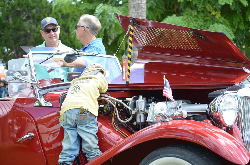 Mike Wheeler, left, and Stu Keen chat about Keen's MG TD-Mark II, which was built in smaller numbers with engine and suspension modifications made for racing.