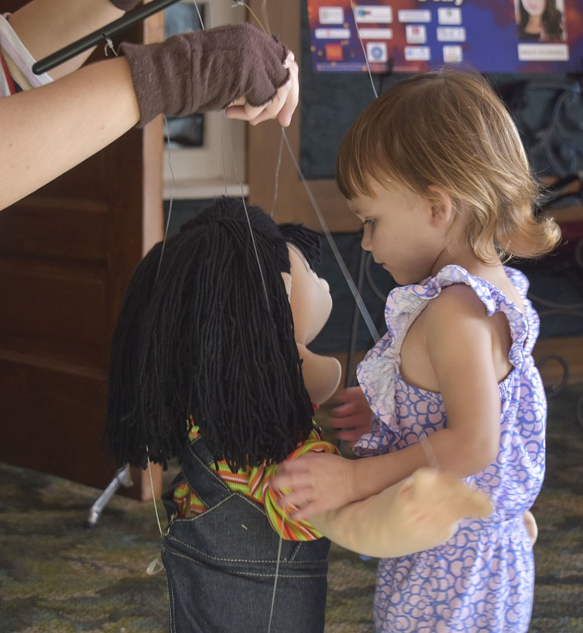 Cora Morgan, 1, hugs the marionette after meeting her.