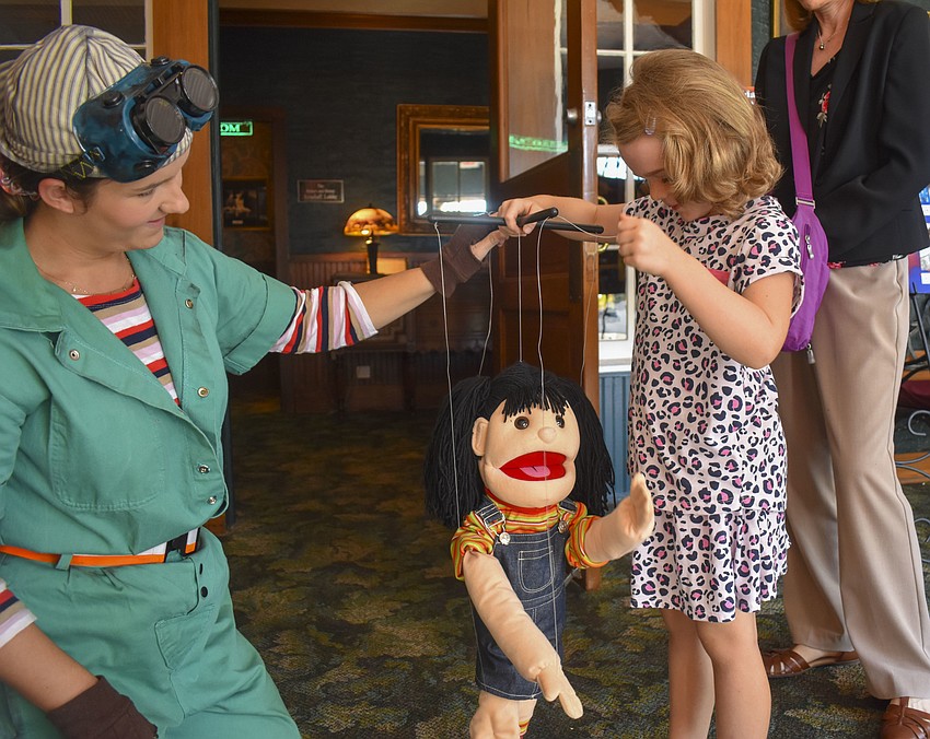Reilly O'Connell teaches Charlotte Allen,7, how to be a puppeteer.
