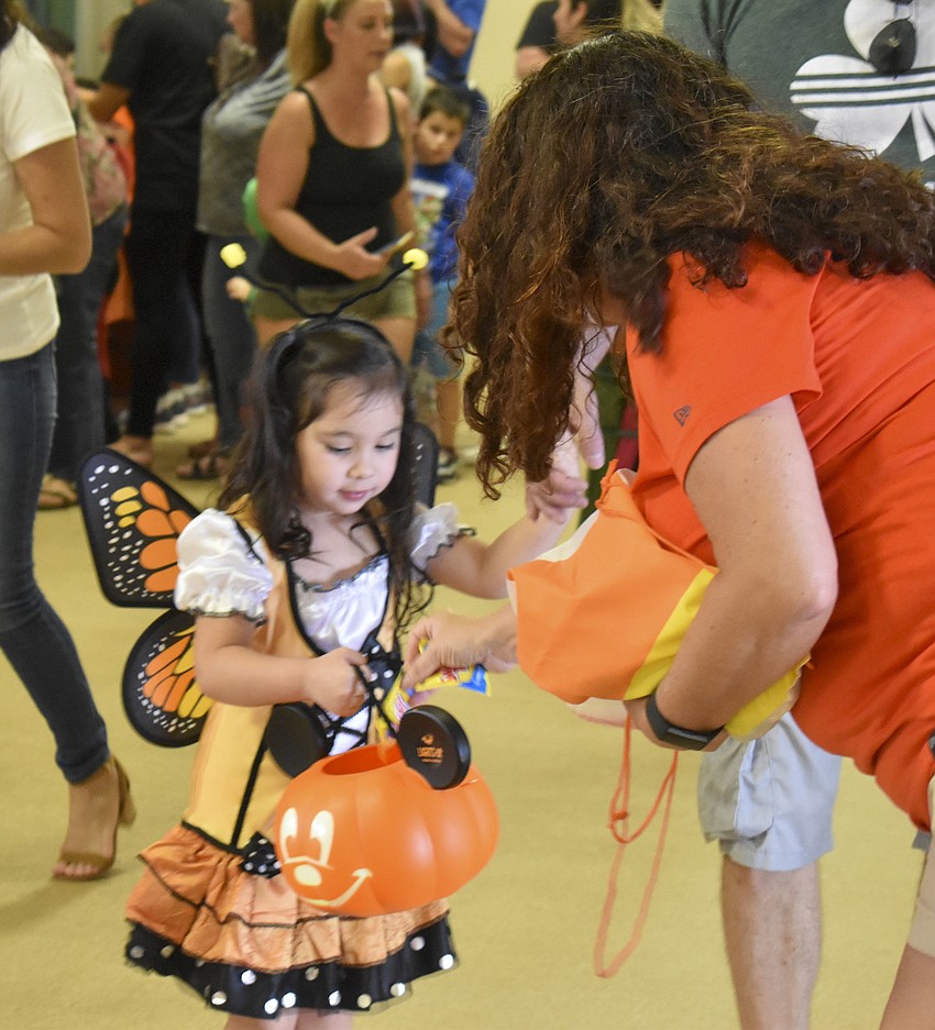 Reagan Reilly trick-or-treats around Ed Smith Stadium.