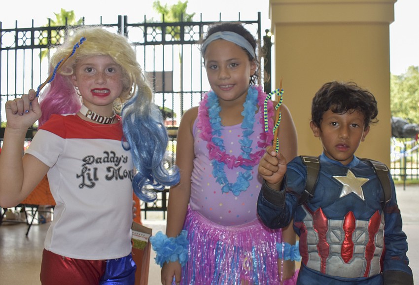 Brylee Edwards, Manuela Cruz and Santiagio Cruz show off their homemade wands.